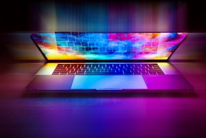Computador portátil iluminado com cores, ilustrando a atualização dos softwares INPO.